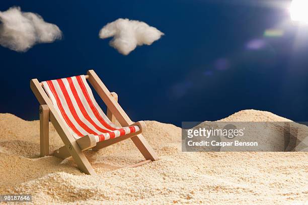 a miniature beach chair in sand - sweet little models stock pictures, royalty-free photos & images