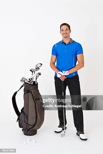 a man standing with golfing equipment - sporthandschuh stock-fotos und bilder