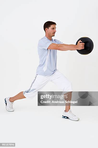 a man exercising with a medicine ball - medicine ball stock pictures, royalty-free photos & images