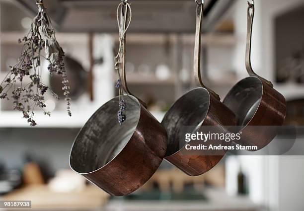 three saucepans hanging from hooks with dried lavender - saucepan - fotografias e filmes do acervo