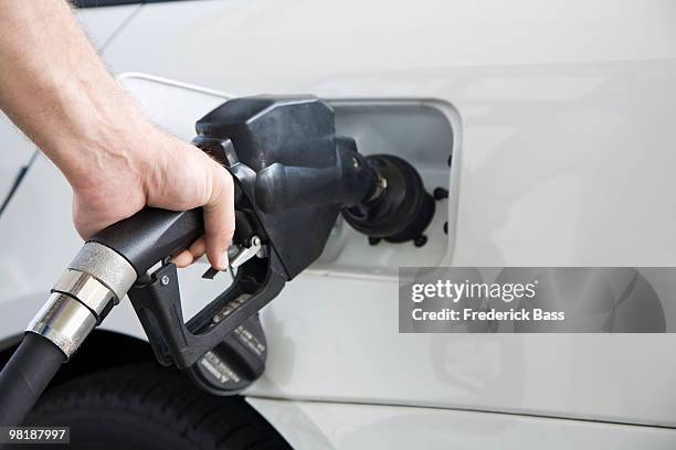 a man's hand pumping gas, close-up - middlebury vermont stock pictures, royalty-free photos & images
