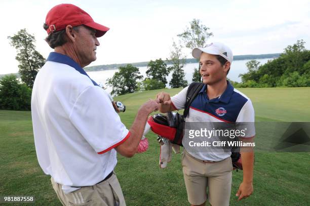 John VanDerLaan of Florida Southern is greeted by Coach Doug Gordon coming off the 18th green after winning the individual championship during the...