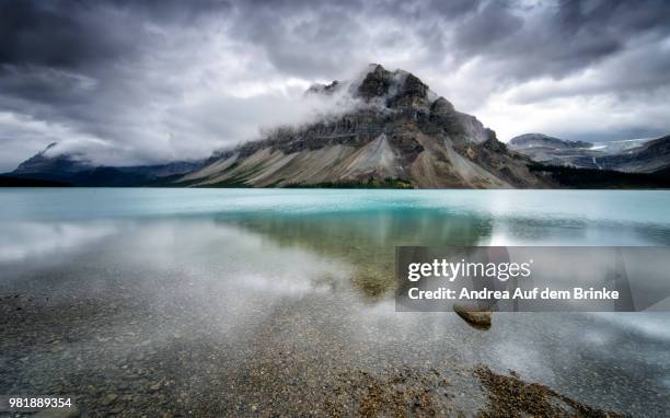 a mountain reflected in bow lake, alberta, canada. - auf dem land stock pictures, royalty-free photos & images