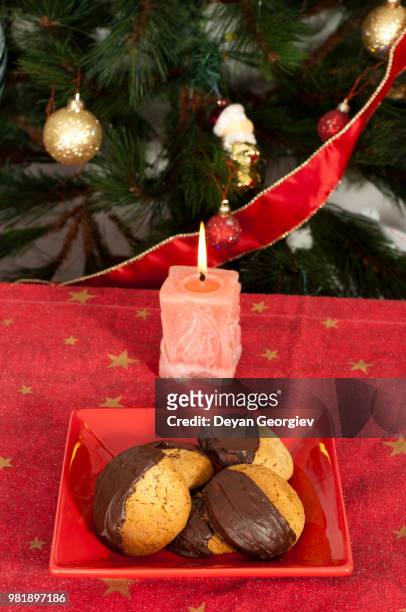 christmas sweets and candle on the table - yolo county stockfoto's en -beelden