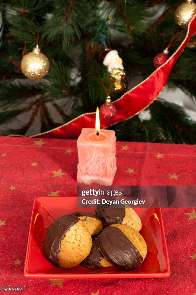 Christmas sweets and candle on the table