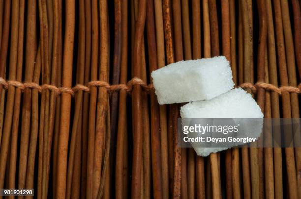 sugar lumps on wooden base - dance cane stock pictures, royalty-free photos & images