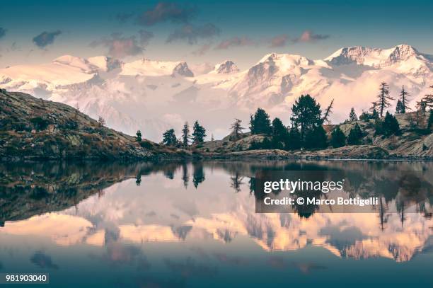 monte rosa reflected in alpine lake - valle daosta stock pictures, royalty-free photos & images