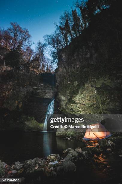 outdoors camping by a waterfall - marco bottigelli stock pictures, royalty-free photos & images