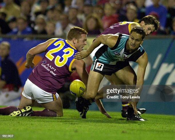Gavin Wanganeen for Port Adelaide defends in the Ansett Cup Grand Final between the Brisbane Lions and Port Power played at Football Park in...