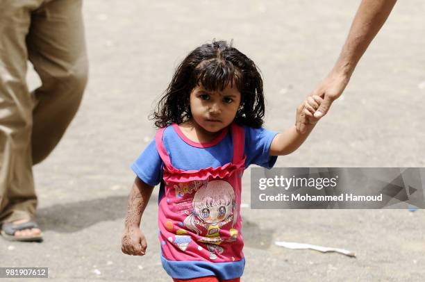 Yemeni displaced girls walk at a shelter after they fled their homes during fighting and airstrikes lunched to capture Yemen's western port city of...