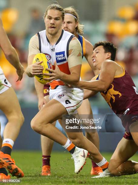 Harry Himmelberg of the Giants looks to handball during the round 14 AFL match between the Brisbane Lions and the Greater Western Sydney Giants at...