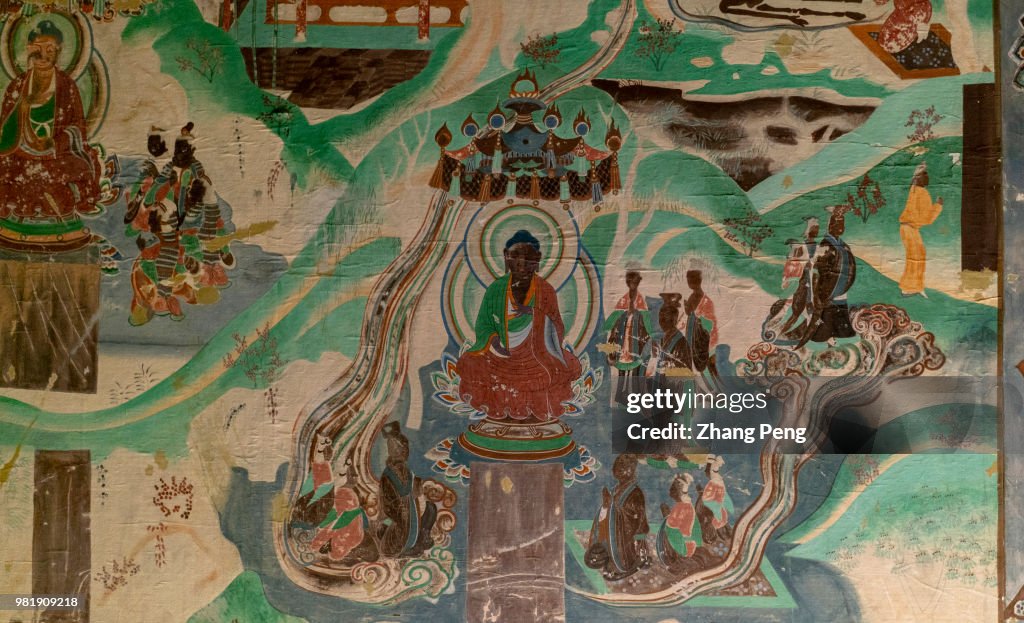 Ancient colorful murals on the cave wall, telling about...