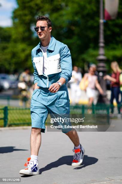 Guest wears a blue and white jacket, blue shorts, sneakers shoes, outside Cerruti, during Paris Fashion Week - Menswear Spring-Summer 2019 on June...