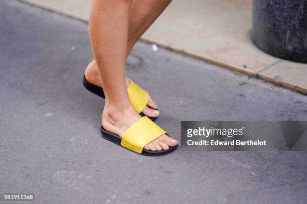 Guest wears yellow sandals, outside CDG Comme des Garcons, during Paris Fashion Week - Menswear Spring-Summer 2019, on June 22, 2018 in Paris, France.