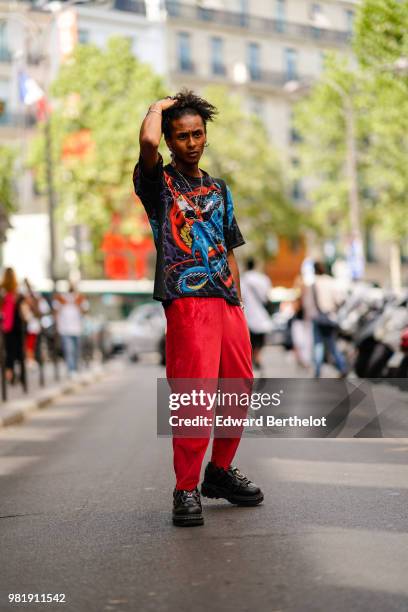 Guest wears a colored top, red pants, outside CDG Comme des Garcons, during Paris Fashion Week - Menswear Spring-Summer 2019, on June 22, 2018 in...