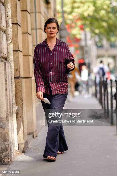 Anastasia Barbieri wears a purple striped shirt, flared pants, outside CDG Comme des Garcons, during Paris Fashion Week - Menswear Spring-Summer...