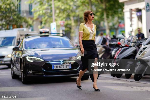 Carine Roitfeld wears a yellow shirt, a black skirt, shoes, outside CDG Comme des Garcons, during Paris Fashion Week - Menswear Spring-Summer 2019,...