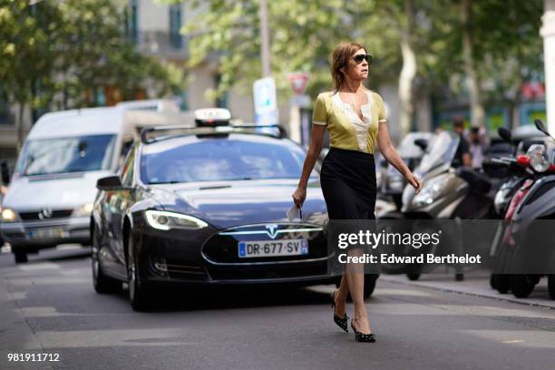 Carine Roitfeld wears a yellow shirt, a black skirt, shoes, outside CDG Comme des Garcons, during Paris Fashion Week - Menswear Spring-Summer 2019,...