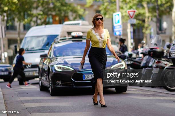 Carine Roitfeld wears a yellow shirt, a black skirt, shoes, outside CDG Comme des Garcons, during Paris Fashion Week - Menswear Spring-Summer 2019,...