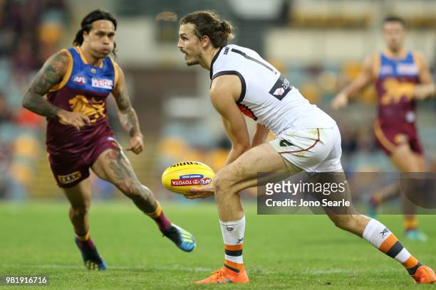 Phil Davis of the Giants handpasses the ball during the round 14 AFL match between the Brisbane Lions and the Greater Western Sydney Giants at The...