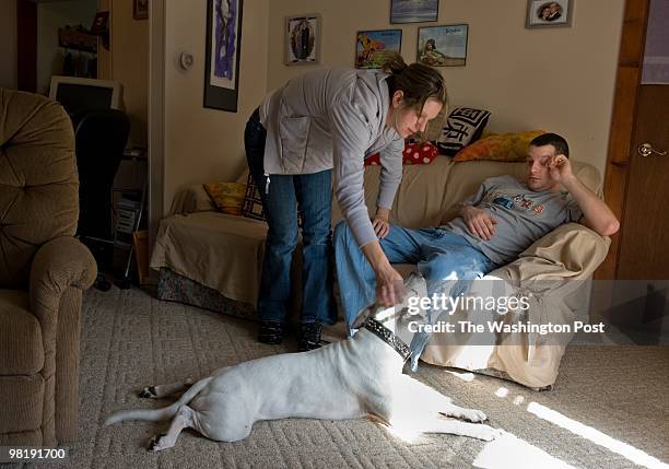 Jennifer and Jason Cline of Monroe, Michigan are pictured in their living room on March 23, 2010. Jennifer is 27, married with two kids, lost her job...