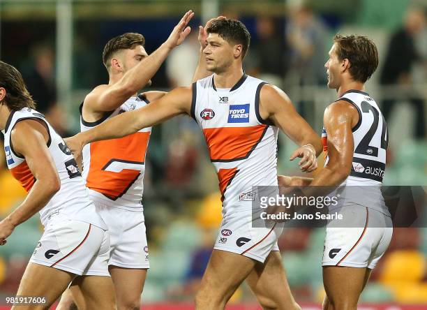 Jonathon Patton of the Giants celebrates a goal with team mates during the round 14 AFL match between the Brisbane Lions and the Greater Western...