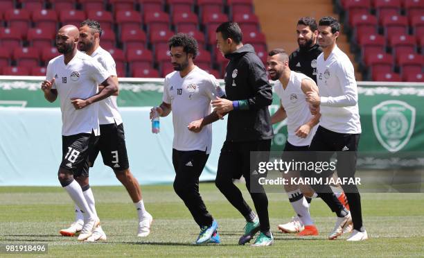 Egypt's forward Mohamed Salah and Egypt's goalkeeper Essam El Hadary jog with Egypt's forward Mahmoud 'Shikabala' Abdel Razek , Egypt's defender...