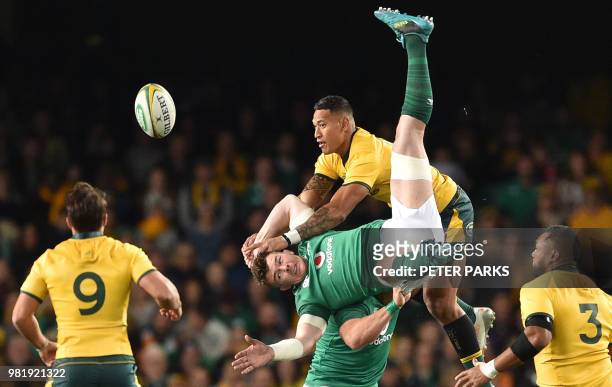 Ireland's Peter O'Mahony and Australian Wallabies Israel Folau jump for the ball during the third and final rugby union Test match between Ireland...