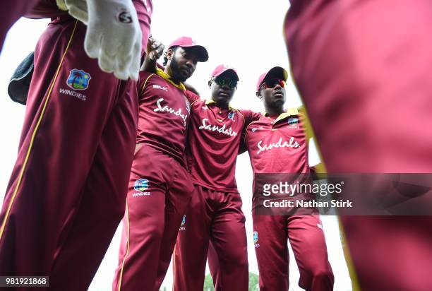 Jomel Warrican, Rovman Powell and Jason Mohammed of West Indies gather in a team huddle before the Tri-Series International match between England...