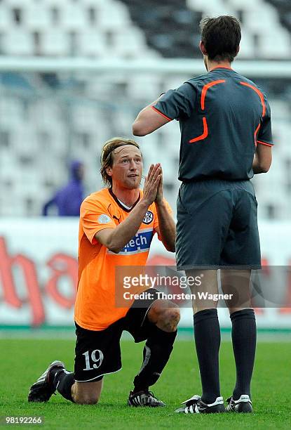 Thomas Scheuring of Aalen is booked yellow card by referee Matthias Joellenbeck during the 4. Liga match between Karlsruher SC II and VfR Aalen at...