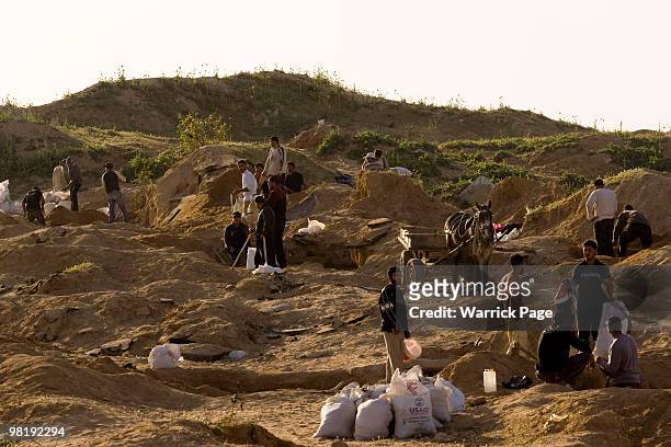 Palestinian workers dig for stone close to the Israeli border March 22, 2010 in Beit Lahiya, Gaza Strip. In the last few months the demand for stone...