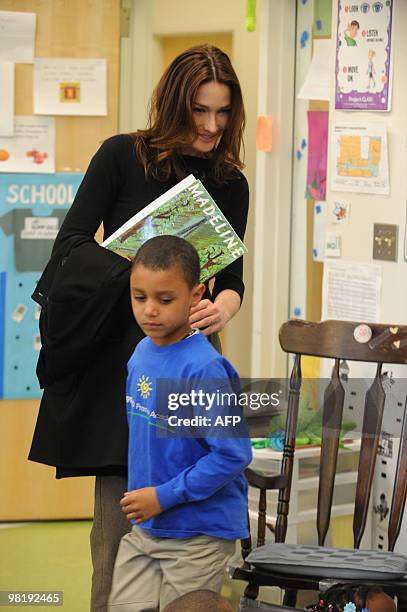 French First Lady Carla Bruni Sarkozy visits with a child at a KIPP school , a school for underprivileged pupils in Washington, DC. AFP...