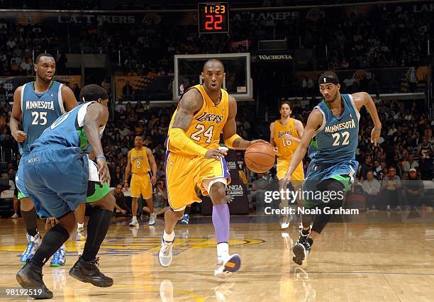 Kobe Bryant of the Los Angeles Lakers drives the ball up court against Jonny Flynn, Corey Brewer and Al Jefferson of the Minnesota Timberwolves...