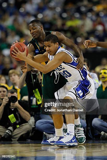 Andre Dawkins of the Duke Blue Devils is fouled by LaceDarius Dunn of the Baylor Bears during the south regional final of the 2010 NCAA men's...