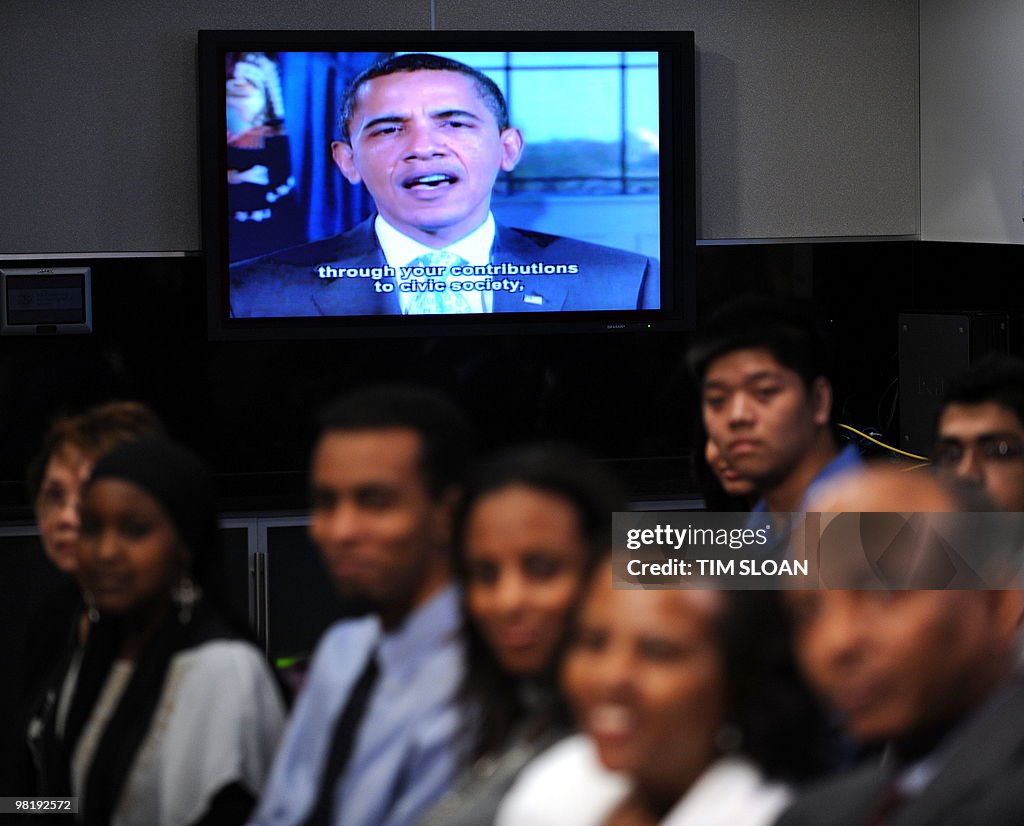 Newly sworn US citizens listen to a vide