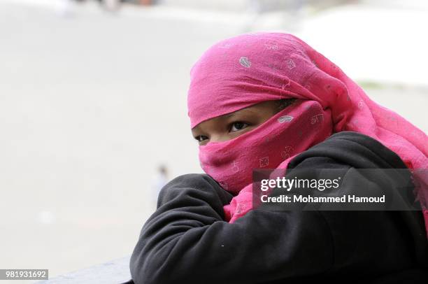 Yemeni displaced woman waits to register her name in order to obtain a shelter after they fleeing during fighting and airstrikes lunched to capture...