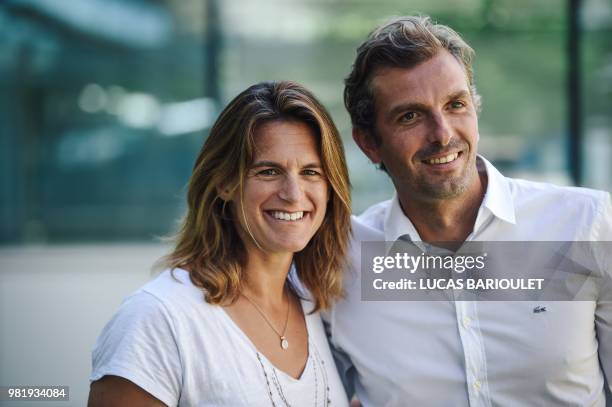 French former tennis players Amelie Mauresmo and Julien Benneteau pose after a press conference on June 23, 2018 in Paris after being respectively...