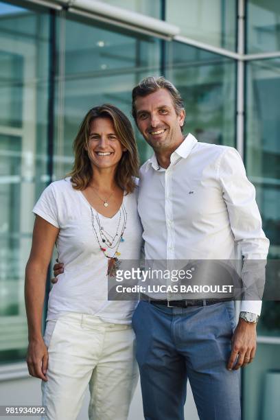 French former tennis players Amelie Mauresmo and Julien Benneteau pose after a press conference on June 23, 2018 in Paris after being respectively...