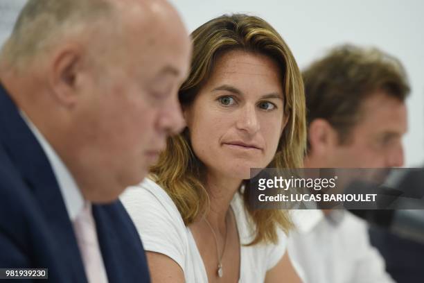 French former world number one Amelie Mauresmo listens to French tennis federation president Bernard Giudicelli during a press conference after she...
