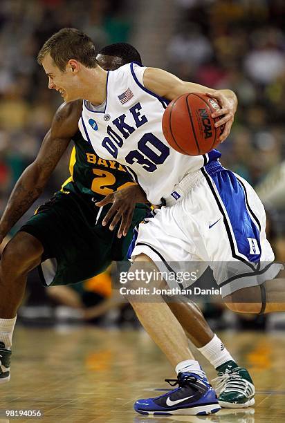 Jon Scheyer of the Duke Dlue Devils moves against LaceDarius Dunn of the Baylor Bears during the south regional final of the 2010 NCAA men's...