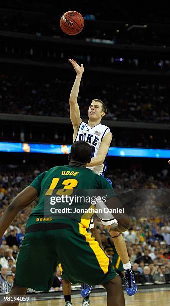 Jon Scheyer of the Duke Dlue Devils leaps to put up a shot over Ekpe Udoh of the Baylor Bears during the south regional final of the 2010 NCAA men's...