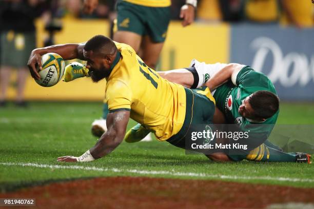 Marika Koroibete of the Wallabies beats the tackle of Johnny Sexton of Ireland to score during the Third International Test match between the...