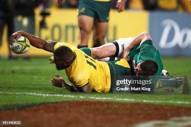 Marika Koroibete of the Wallabies beats the tackle of Johnny Sexton of Ireland to score during the Third International Test match between the...