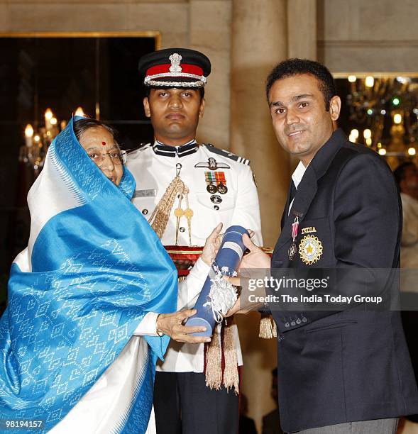 Cricketer Virender Sehwag receives the Padma Shri from President Pratibha Patil at the Rashtrapati Bhavan in New Delhi on Wednesday, March 31, 2010.