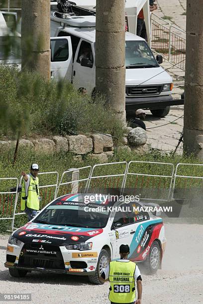 Portugal's Armindo Araujo drives his Mitsubishi at the start of the Jordan Rally of the FIA World Rally Championship in the ancient city of Jarash,...