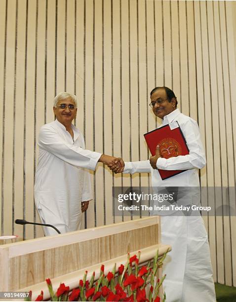Union Home Minister P Chidambaram shakes hands with Union Minister for Minority Affairs Salman Khurshid during the Annual Conference of State...