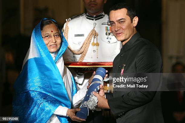 President Pratibha Patil presenting Padma Bhushan Award to actor Aamir Khan for his contribution to Indian cinema at the 2010 Padma awards...