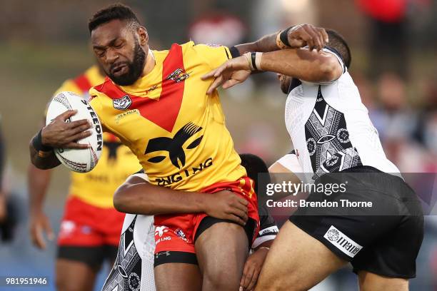 Junior Rau of PNG is tackled by the Fijian defence during the 2018 Pacific Test Invitational match between Fiji and Papua New Guinea at Campbelltown...