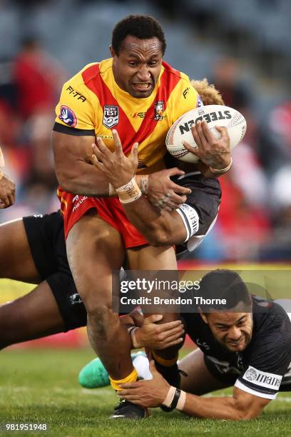 Justin Olam of PNG is tackled by the Fijian defence during the 2018 Pacific Test Invitational match between Fiji and Papua New Guinea at Campbelltown...