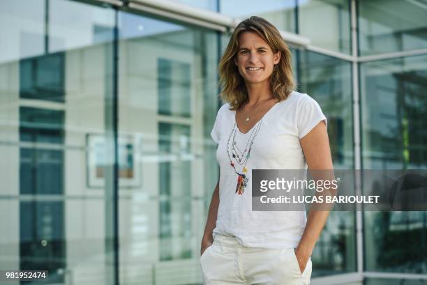 French former world number one Amelie Mauresmo poses following a press conference after she became the first woman appointed to captain France's...